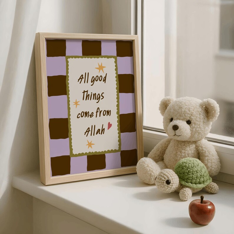 May include: A framed print featuring a light purple and dark brown checkered background with a central cream-colored rectangle containing the text "All good things come from Allah" in dark brown, accented by small yellow stars and a red heart.