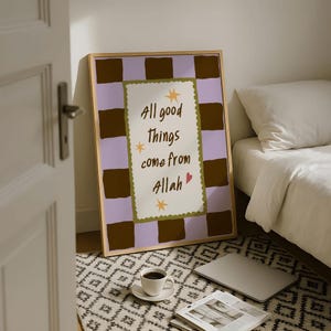 May include: A framed rectangular wall art print featuring a light purple and dark brown checkerboard pattern. The center contains a white scalloped rectangle with the text All good things come from Allah, accented by yellow stars and a small red heart.