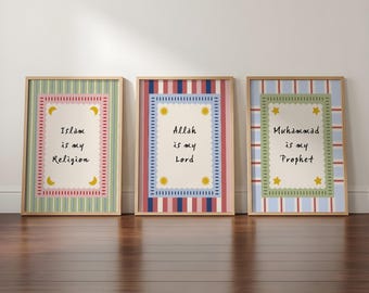 May include: Three framed wall art prints with light wood frames. The left print has green stripes and text reading Islam is my Religion. The center print has red and blue stripes and text reading Allah is my Lord. The right print has blue stripes and text reading Muhammad is my Prophet.
