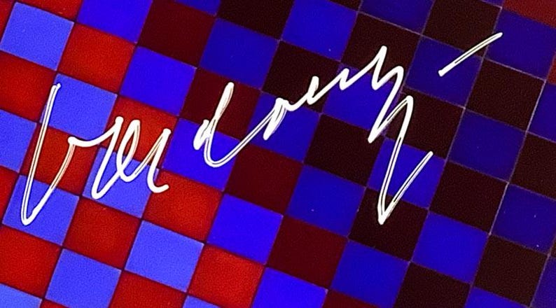 May include: Abstract design featuring a checkered pattern in red, blue, and dark blue. White cursive text is overlaid on the pattern. The image has a vibrant, colorful aesthetic.