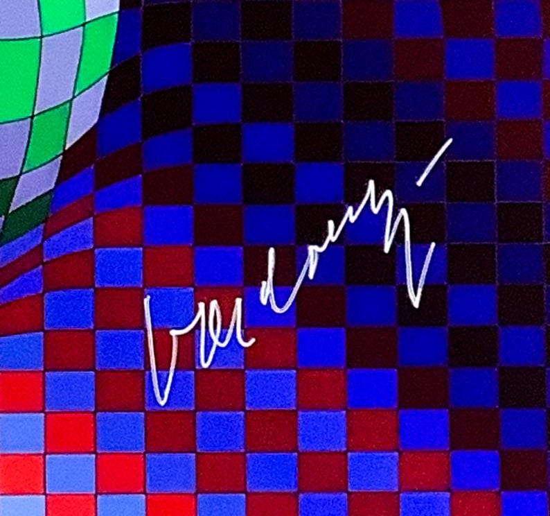 May include: Abstract artwork with a checkered pattern in shades of blue, red, and black, with a green and purple section in the upper left. White cursive text is overlaid on the design.