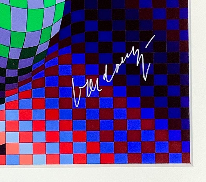 May include: Abstract art print featuring a vibrant, checkered pattern in shades of blue, red, and green. The artwork includes a signature in white. The design is framed in a white border.
