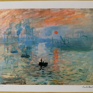 May include: A print of a seascape painting with a red sun setting over the water. The painting features boats, buildings, and reflections in shades of blue, orange, and green. The artist's signature is in the bottom right corner.