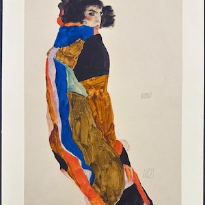 May include: A print of an Egon Schiele artwork featuring a figure with dark hair, wearing a garment with bold blocks of blue, brown, black, and orange. The print includes the text 62/130, a signature, and the name Egon Schiele in the bottom corner.