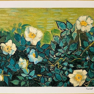 May include: A print of a painting by Vincent van Gogh, featuring white roses with yellow centers and teal leaves. The artwork has a textured appearance, with visible brushstrokes. The background is a light green color. The print is numbered 203/300.