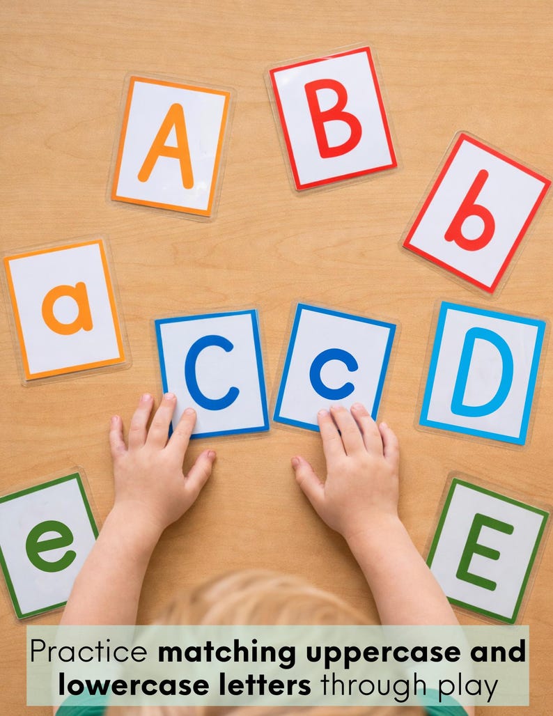 May include: A set of rectangular educational cards featuring uppercase and lowercase letters of the alphabet in various colors including orange, red, blue, and green, arranged on a surface for matching practice.