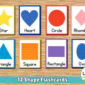 May include: A set of eight educational flashcards featuring various shapes including a yellow star, blue heart, red circle, pink rhombus, blue triangle, orange square, purple rectangle, and blue oval, each labeled with its corresponding name.