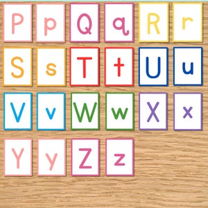 May include: A set of rectangular cards featuring the letters P through Z in both uppercase and lowercase formats. Each card has a colored border matching the letter color, including pink, yellow, orange, red, blue, green, purple, and magenta.