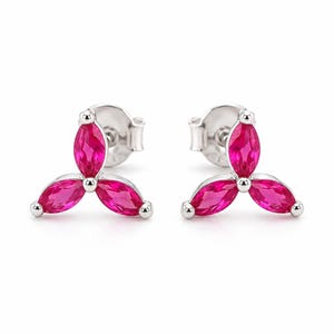 May include: A pair of stud earrings featuring three marquise-cut vibrant pink stones arranged in a clover-like cluster. The stones are set in a polished silver-toned metal frame, with each earring including a standard post and butterfly back closure.