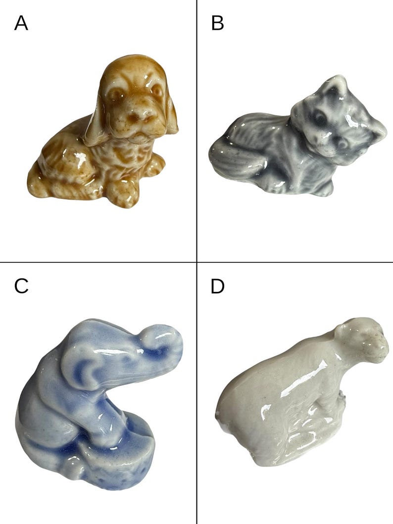 May include: Four small ceramic animal figurines: a tan dog, a gray cat, a blue elephant, and a white bear. Each figurine is detailed and appears to be hand-painted, showcasing a glossy finish. The animals are in various poses.