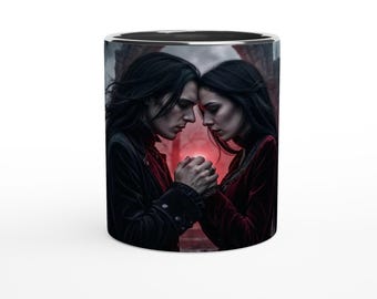 May include: A ceramic mug with a black interior and silver rim. The mug features a gothic-themed image of two people with long dark hair, holding hands, and looking down. They are dressed in dark red and black clothing.