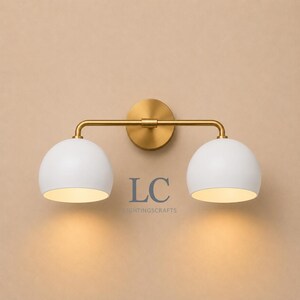 double wall sconce
brass vanity light
modern wall fixture
dual arm wall light
bathroom wall light
mid century light
vanity light brass
minimalist light
wall light fixture
home decor light
luxury wall light
vanity light
colorful sconce
vanity light, wall sconce, handcrafted light, modern vanity light, handmade lamp, brass wall sconce, dome shade light, triple vanity light, minimalist lighting, brass light, 3 light sconce, mid-century light, bathroom  fixture