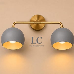 double wall sconce
brass vanity light
modern wall fixture
dual arm wall light
bathroom wall light
mid century light
vanity light brass
minimalist light
wall light fixture
home decor light
luxury wall light
vanity light
colorful sconce
vanity light, wall sconce, handcrafted light, modern vanity light, handmade lamp, brass wall sconce, dome shade light, triple vanity light, minimalist lighting, brass light, 3 light sconce, mid-century light, bathroom  fixture