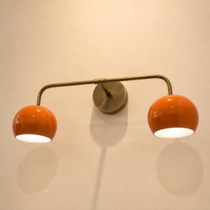 double wall sconce
brass vanity light
modern wall fixture
dual arm wall light
bathroom wall light
mid century light
vanity light brass
minimalist light
wall light fixture
home decor light
luxury wall light
orange Wall Light
Orange Sconce
vanity wall sconce, wall mounted sconce, flush mount sconce, bathroom Bedroom wall Sconce, Dome Shade Light, Double Arm Sconce, Reading Light, Wall Fixture Lamp, Italian wall Sconce, hallway Wall Sconce, Double Arm Fixture, Brass Wall Sconce, Modern Wall Lamp
