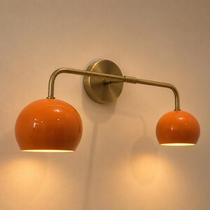 double wall sconce
brass vanity light
modern wall fixture
dual arm wall light
bathroom wall light
mid century light
vanity light brass
minimalist light
wall light fixture
home decor light
luxury wall light
orange Wall Light
Orange Sconce
vanity wall sconce, wall mounted sconce, flush mount sconce, bathroom Bedroom wall Sconce, Dome Shade Light, Double Arm Sconce, Reading Light, Wall Fixture Lamp, Italian wall Sconce, hallway Wall Sconce, Double Arm Fixture, Brass Wall Sconce, Modern Wall Lamp