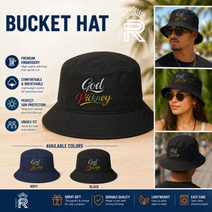 May include: Black bucket hat with the embroidered text "God Pickney" in white, red, yellow, and green. The hat is shown in navy and black. The hat is lightweight, unisex, and provides sun protection.