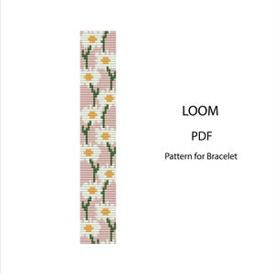 Op de afbeelding: Een digitaal patroon voor een armband met een madelief bloemenontwerp. Het patroon toont witte madeliefjes met gele centra en groene stelen op een roze achtergrond. De tekst luidt "LOOM PDF Pattern for Bracelet."