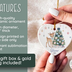 May include: Heart-shaped ceramic ornament featuring a deer and Christmas tree design. The ornament is 3 inches in diameter and 1/8 inch thick. The design is printed on one side with a vibrant sublimation print. The name "Oliver" and the year "2025" are printed on the ornament.
