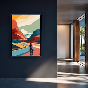 May include: A framed art print showing a cyclist in a canyon. The artwork uses a vibrant palette of orange, red, blue, and yellow. The cyclist is seen from behind, adding a sense of movement. The landscape is stylized, with a focus on the natural scenery.