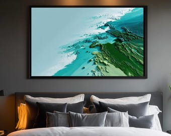 May include: A framed print of a topographical map in shades of blue, green, and white. The artwork is displayed above a bed with grey pillows and a white duvet. The frame is black.