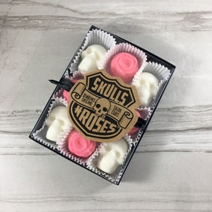 Tile background with box of skull shaped sugar cubes and pink rose shaped sugar cubes, each sugar cube sits in a candy cup in a grid, Kraft labels read: Skulls N Roses, DemBones Original, Sugar Cubes