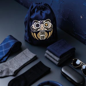 May include: A set of three ceramic mugs with a speckled, matte finish. The mugs are in shades of cream, light gray, and dark gray. Each mug has a simple, minimalist design, perfect for coffee or tea.