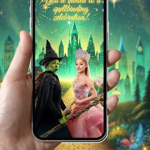 May include: A smartphone displays a digital invitation with the text "You're invited to a spellbinding celebration!" The image features two characters from the musical "Wicked" in front of a green city backdrop.