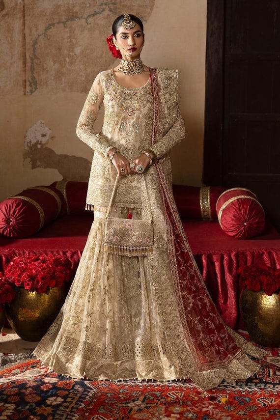 nikah designer dresses Pretty Bride in Traditional Custom made Red Nikah Dress to feel Essence of New Journey with Life Partner #bridaldress #nikahdress #daughtermotherbridal #motherformaldress #redgoldbridal #bridaldressdesigner #bridaldressstudio #bridaldresspakistan