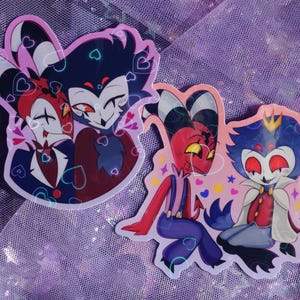 May include: Two cartoon stickers featuring characters with red, blue, and white color schemes. The stickers have heart and star accents. One sticker shows two characters embracing, while the other shows two characters sitting together.