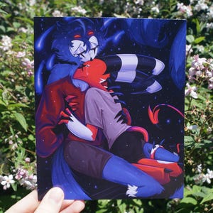 May include: A rectangular art print featuring a digital illustration of two anthropomorphic characters embracing against a dark blue starry background. One character is tall with blue fur and red markings, while the other is red with black and white horns.