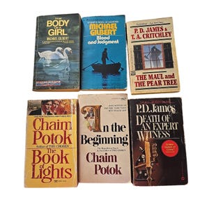 May include: A collection of six vintage books with worn covers. Titles include "The Body of a Girl," "Blood and Judgment," "The Maul and the Pear Tree," "The Book of Lights," "In the Beginning," and "Death of an Expert Witness." The books are in various colors.