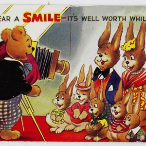 May include: Vintage postcard illustration featuring a bear playing an accordion and photographing a group of anthropomorphic rabbits. The rabbits are dressed in various outfits. The text "WEAR A SMILE - IT'S WELL WORTH WHILE!" is displayed at the top.
