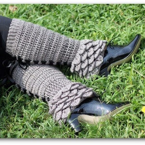 May include: Gray crocheted leg warmers with a scalloped edge and black patent leather shoes. The leg warmers are worn over black leggings.