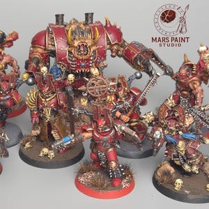 May include: A collection of red and gold miniature figurines, possibly for tabletop gaming. The figures are detailed with weapons and armor, set on various bases. The Mars Paint Studio logo is visible in the background.