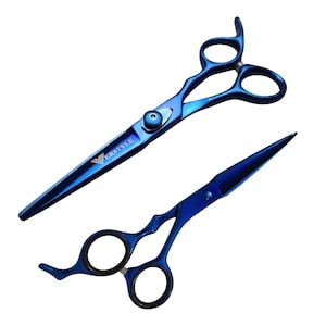 May include: A pair of professional hair cutting shears with a metallic blue finish. The blades feature the brand name VERSTYLE printed in white. The handles include two finger rings and a finger rest, with black rubber inserts inside the rings.