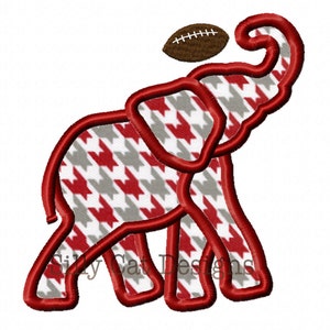 May include: Red and gray houndstooth patterned elephant holding a brown football above its head.