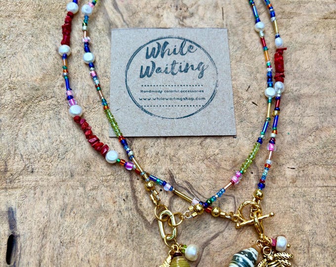 Friendship necklace with charms- coral, peridot, freshwater pearl, gold, bee & fish charm