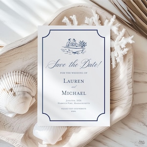 May include: A white wedding invitation with a navy blue border and text. The invitation reads "Save the Date!" and includes the names Lauren and Michael, the wedding date, and location. A boat illustration is at the top. The invitation is on a wooden tray with seashells.