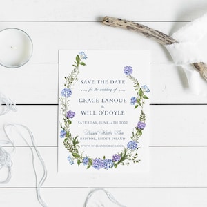 May include: Save the date card with a floral wreath design in shades of blue and green. The text reads "Save the Date... for the wedding of... Grace Lanoue & Will O'Doyle. Saturday, June, 4th 2022. Bristol Harbor Inn. Bristol, Rhode Island. www.willandgrace.com"