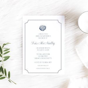 May include: A white invitation with a navy blue border and a seashell graphic. The invitation is for a bridal shower brunch in honor of Fris McNulty. The event will be held on Saturday, May 12th from 11:00 AM to 3:00 PM at The Danl Webster Inn, 149 Main Street, Sandwich, Massachusetts. The invitation requests an RSVP by April 25th and states that the bride's registry is at Macy's.