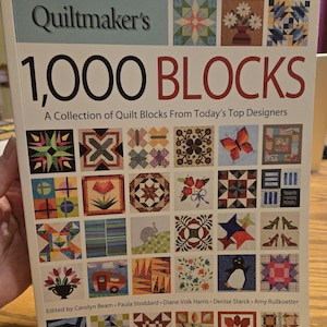 May include: A handmade wooden sign with the text "Welcome" in a playful font. The sign is painted white with a distressed finish, and features a decorative floral design in shades of pink and green. It is designed for indoor or outdoor use.