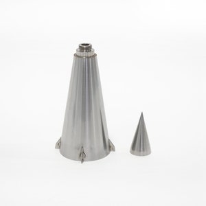 May include: A silver metal bottle stopper in the shape of a cone with a smaller cone on the side. The bottle stopper has a threaded top.