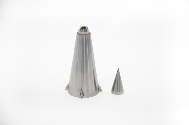 May include: A silver metal bottle stopper in the shape of a cone with a smaller cone on the side. The bottle stopper has a threaded top.
