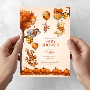 Puede incluir: Una tarjeta de invitación para baby shower con personajes de Winnie the Pooh, hojas de otoño y calabazas. El texto dice: PLEASE JOIN US FOR A BABY SHOWER HONORING Maddie THURSDAY, 30 JULY, AT 3:30PM 125 WILLOW LANE, ROSEWOOD, CA 90210.