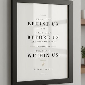 May include: A framed print with a black border, featuring the quote "What Lies Behind Us and What Lies Before Us Are Tiny Matters Compared to What Lies Within Us." The text is in a classic serif font.
