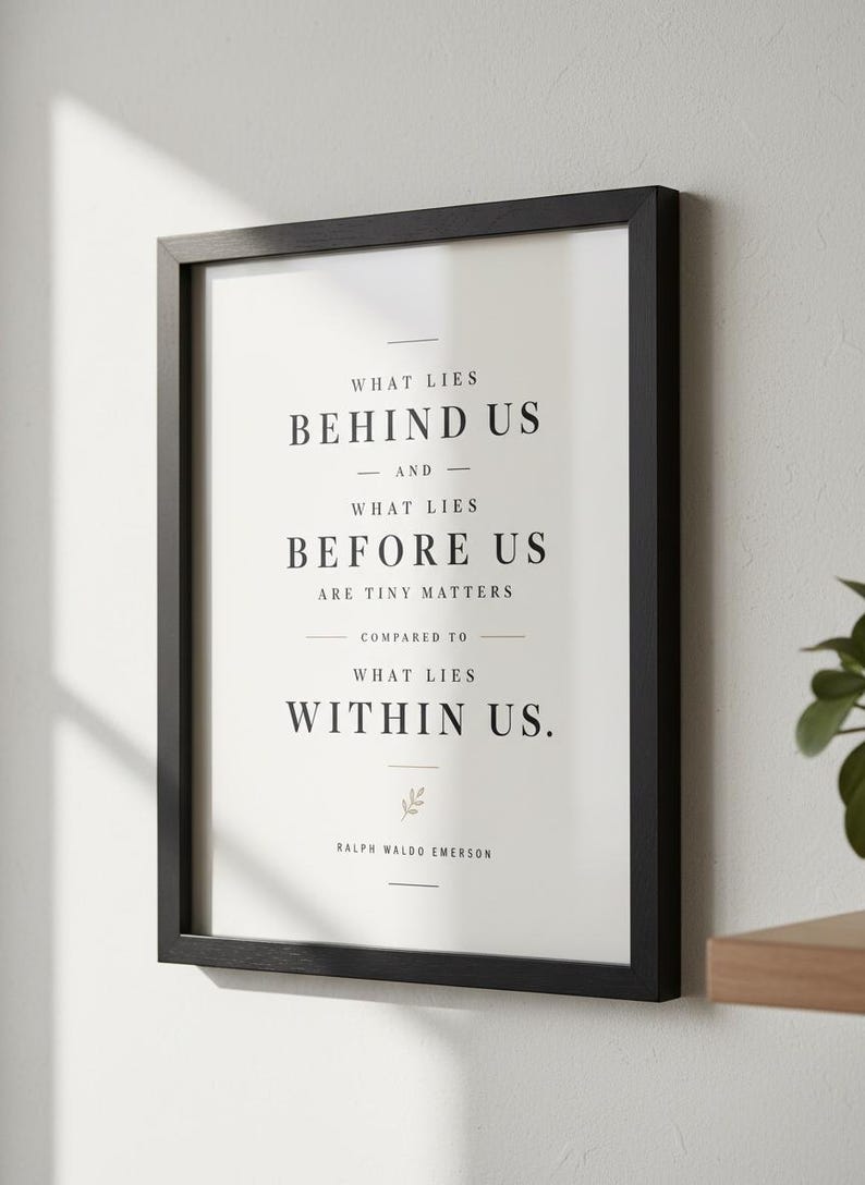 May include: A framed print with a black wooden frame. The print features the quote "What lies behind us and what lies before us are tiny matters compared to what lies within us." by Ralph Waldo Emerson, in a minimalist style.