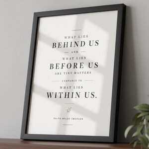 May include: Black framed print with the quote "WHAT LIES BEHIND US - AND - WHAT LIES BEFORE US ARE TINY MATTERS COMPARED TO WHAT LIES WITHIN US." by Ralph Waldo Emerson. The print is on a white background.