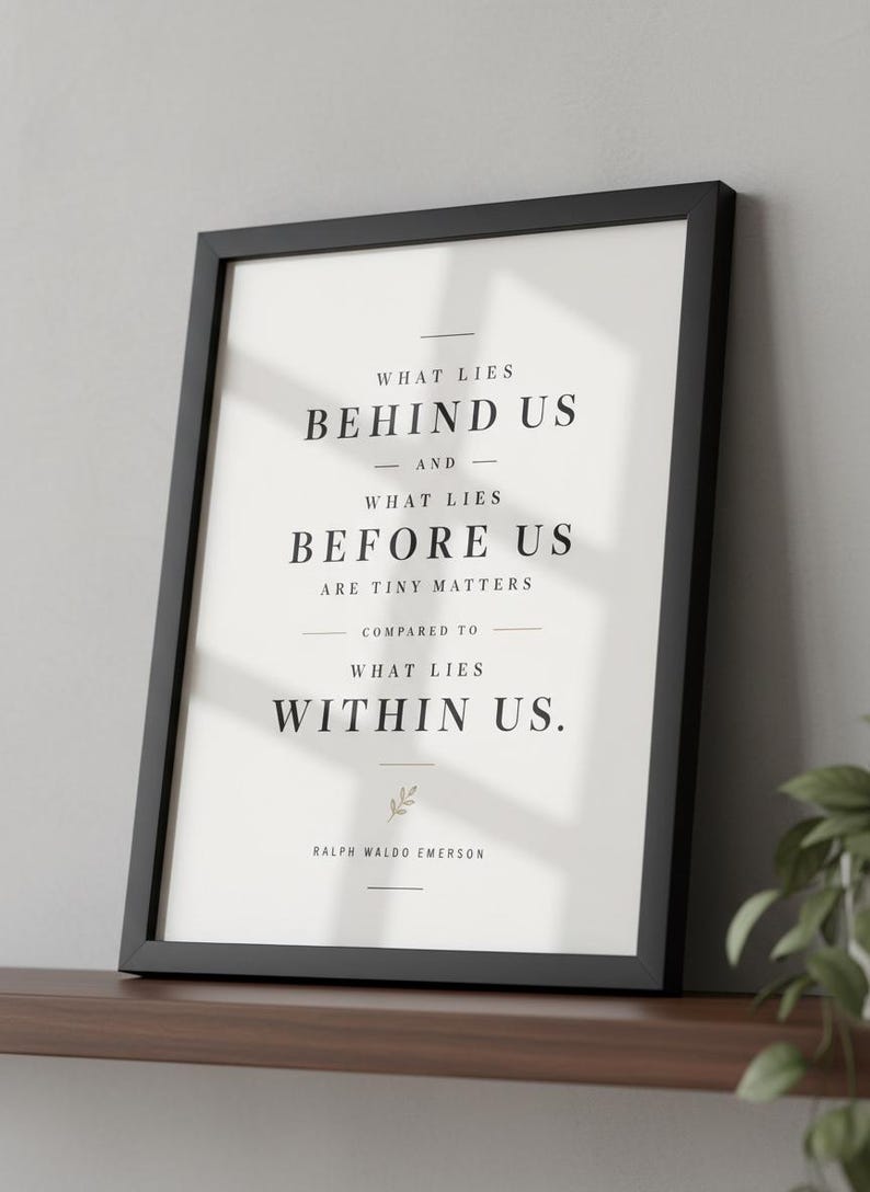May include: Black framed print with the quote "WHAT LIES BEHIND US - AND - WHAT LIES BEFORE US ARE TINY MATTERS COMPARED TO WHAT LIES WITHIN US." by Ralph Waldo Emerson. The print is on a white background.
