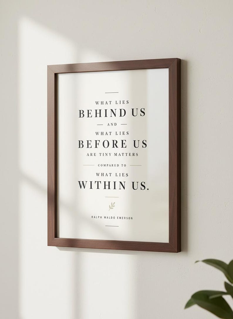 May include: A framed print with a dark brown wooden frame. The print features the quote "What lies behind us and what lies before us are tiny matters compared to what lies within us." by Ralph Waldo Emerson.