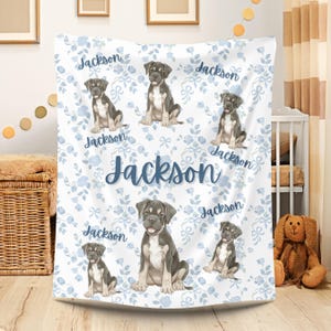 May include: A set of three ceramic mugs with a speckled, matte finish. Each mug features a different color: light blue, cream, and gray. The mugs have a simple, modern design with a rounded shape and a comfortable handle.